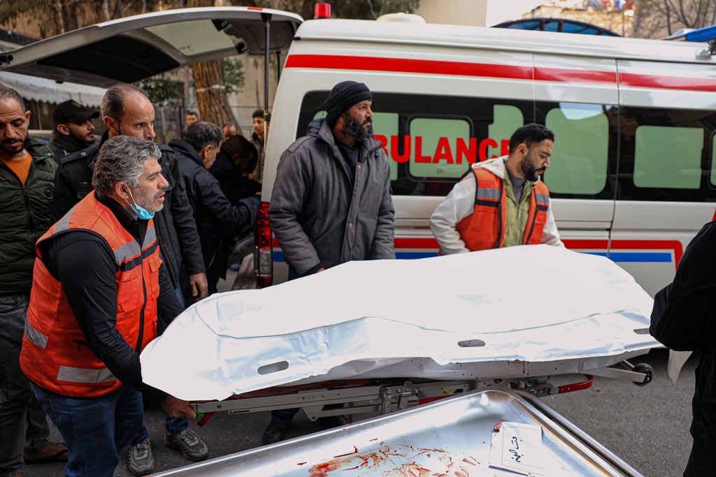 The body of one of the victims of an Israeli forces raid in the southern Syrian village of Beit Jin is brought to Al-Mowasat Hospital in Damascus, Friday, Nov. 28, 2025. (AP Photo/Omar Albam)