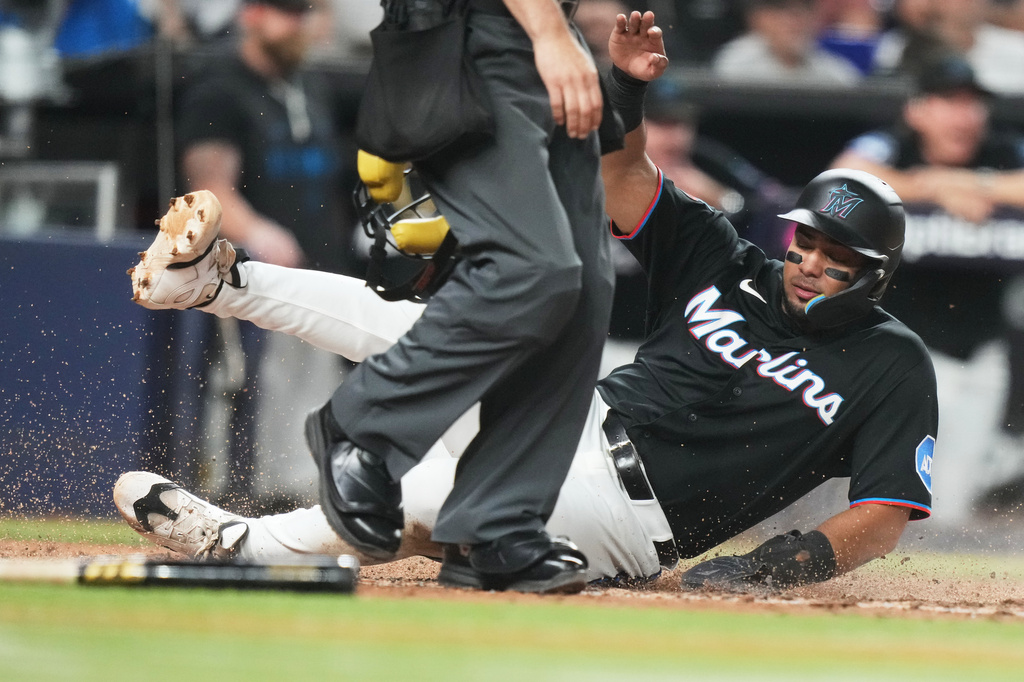 Miami Marlins' Leo Jimenez scores on a sacrifice fly hit by Brian Navarreto during the fifth inning of a baseball game against the Boston Red Sox, Tuesday, Aug. 25, 2026, in Miami. (AP Photo/Lynne Sladky)