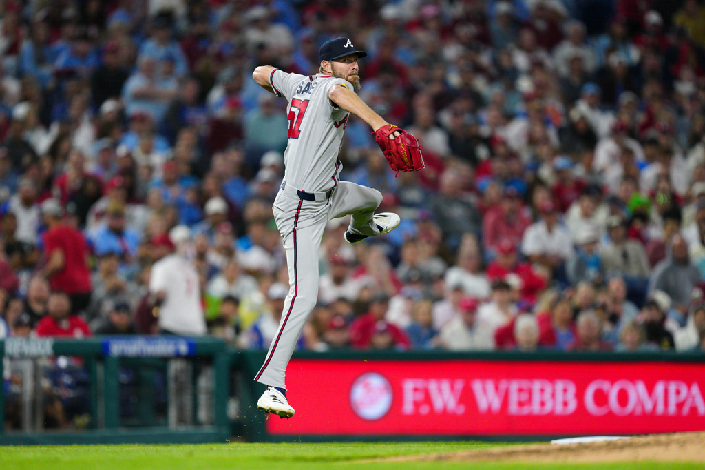 Atlanta Braves pitcher Chris Sale throws to first base after fielding an infield single by Philadelphia Phillies' Edmundo Sosa during the fifth inning of a baseball game, Saturday, April 18, 2026, in Philadelphia. (AP Photo/Derik Hamilton)