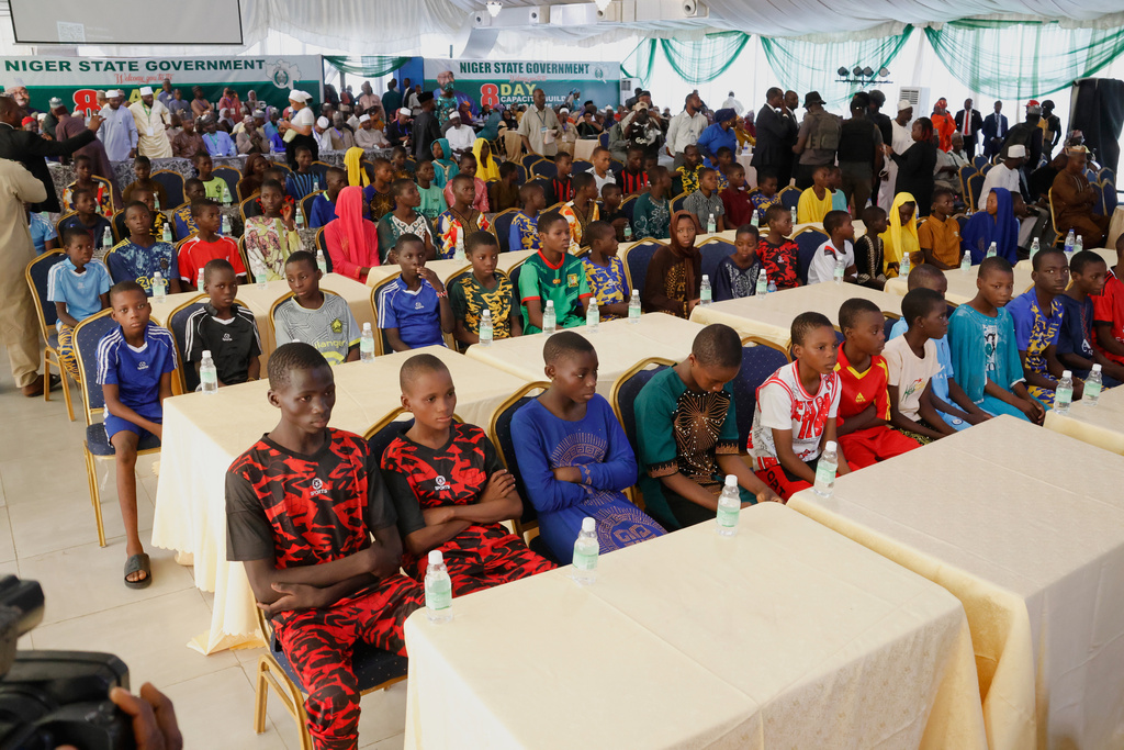 Freed students of the St. Mary's Catholic School in the Papiri community upon arrival at the government house in Minna, Nigeria, Monday, Dec. 8, 2025. (AP Photo)
