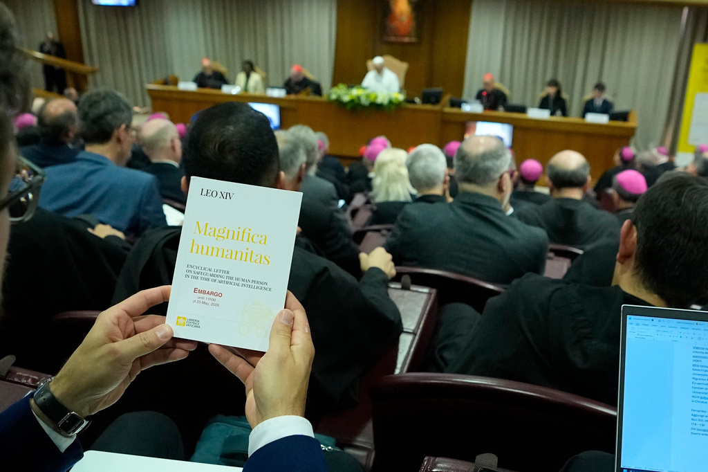 Pope Leo XIV, left, attends the presentation of his first encyclical, "Magnifica humanitas: On Safeguarding the Human Person in the Time of Artificial Intelligence," at the Vatican, Monday, May 25, 2026. (AP Photo/Alessandra Tarantino)