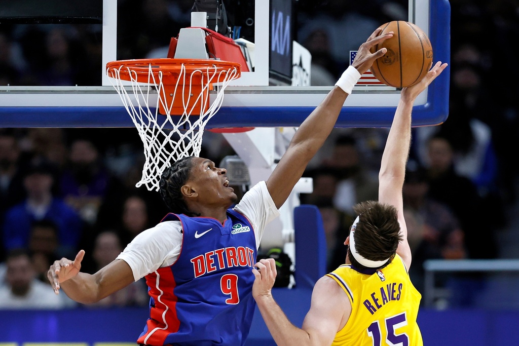 Detroit Pistons guard Ausar Thompson (9) blocks a shot-attempt by Los Angeles Lakers guard Austin Reaves (15) during the first half of an NBA basketball game Monday, March 23, 2026, in Detroit. (AP Photo/Duane Burleson)