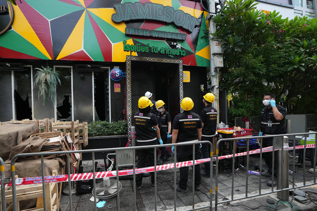 Forensic police officers inspect the site of a fire in Bangkok, Thailand, Monday, July 13, 2026. (AP Photo/Sakchai Lalit)