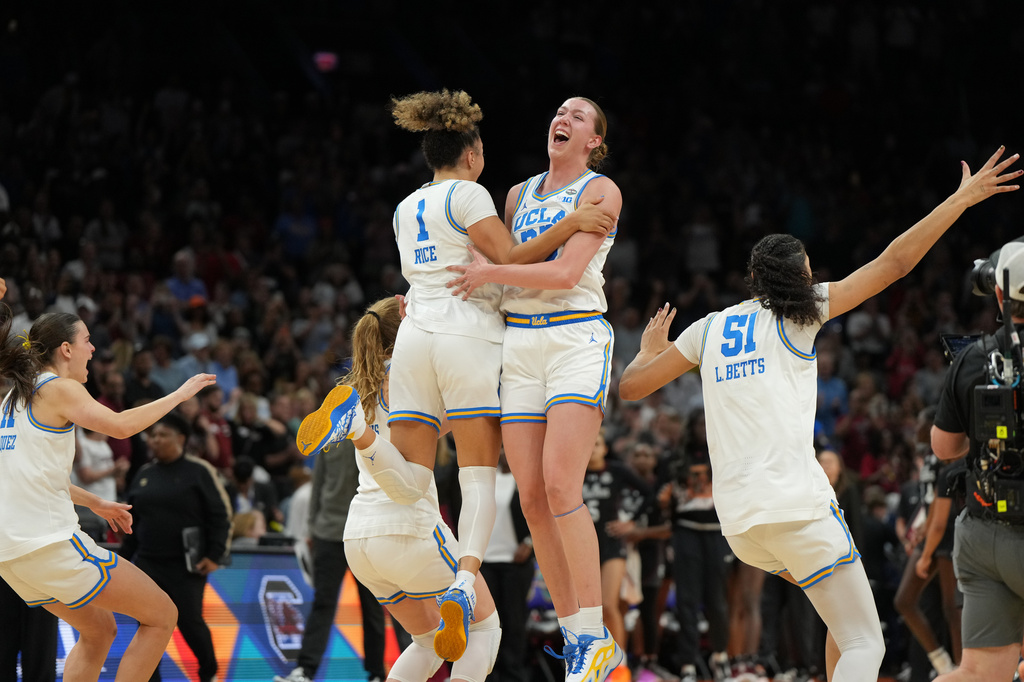 UCLA guard Kiki Rice (1) and UCLA forward Amanda Muse (33) celebrate after defeating South Carolina in the women's National Championship Final Four NCAA college basketball tournament game, Sunday, April 5, 2026, in Phoenix. (AP Photo/Rick Scuteri)