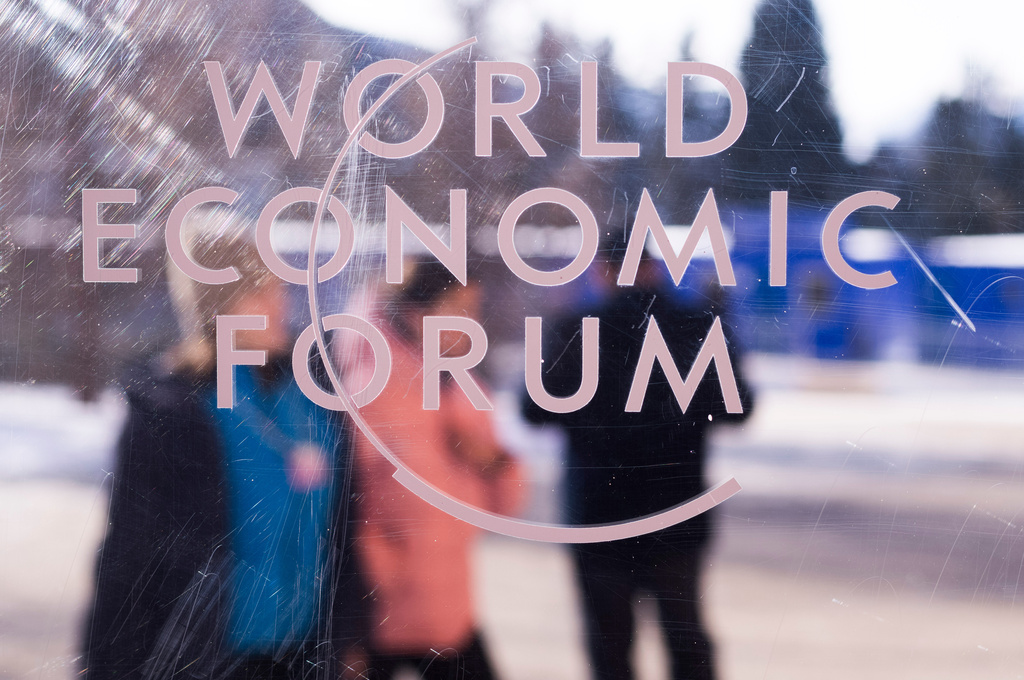 The logo of the World Economy Forum is displayed on a window of the Congress Center where the Annual Meeting Forum take place in Davos, Switzerland, Sunday, Jan. 18, 2026. (AP Photo/Markus Schreiber)