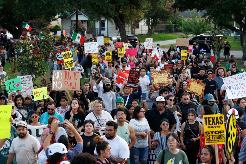 People march during a vigil for Lorenzo Salgado Araujo, a Mexican national fatally shot by a federal immigration agent a day prior, Wednesday, July 8, 2026, in Houston. (AP Photo/Mark Felix)