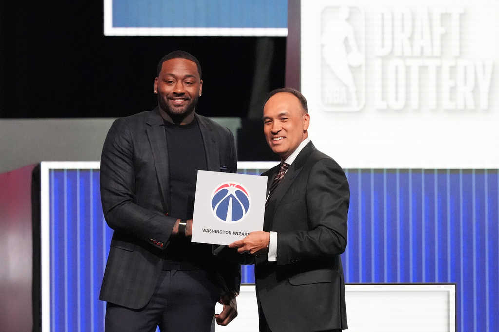 Washington Wizards' John Wall, left, and NBA Deputy Commissioner Mark Tatum, pose for photos after Tatum announced that the Wizards had won the first pick in the NBA basketball draft lottery in Chicago, Sunday, May 10, 2026. (AP Photo/Nam Y. Huh)