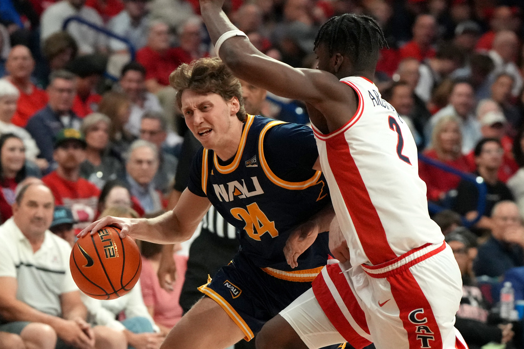 Northern Arizona guard Isaiah Shaw (24) drives on Arizona guard Dwayne Aristode during the first half of an NCAA college basketball game, Tuesday, Nov. 11, 2025, in Tucson, Ariz. (AP Photo/Rick Scuteri)