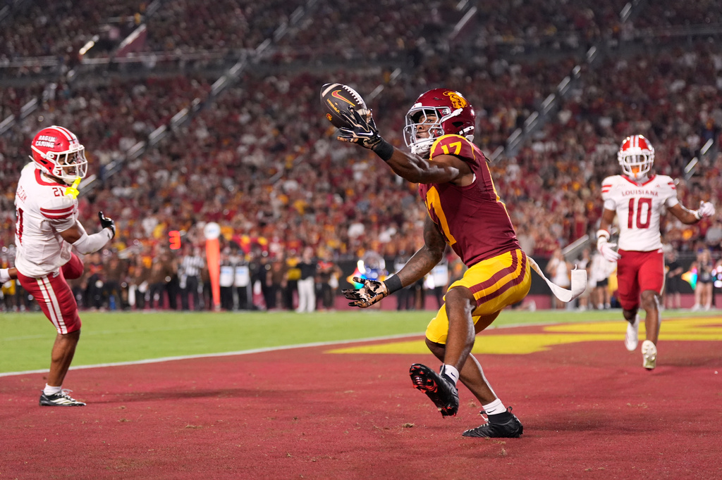 Southern California wide receiver Kayden Dixon-Wyatt, center, makes a touchdown catch as Louisiana safety Maurion Eleam, left, and cornerback Avery Demery defend during the first half of an NCAA college football game, Saturday, Sept. 12, 2026, in Los Angeles. (AP Photo/Mark J. Terrill)