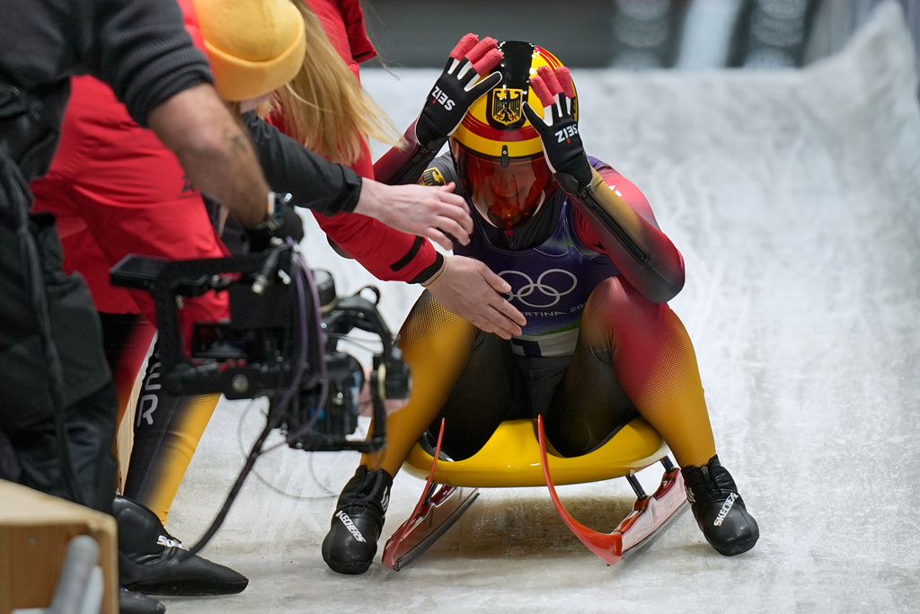 Germany's Julia Taubitz celebrates winning the gold medal during a women's single luge competition at the 2026 Winter Olympics, in Cortina d'Ampezzo, Italy, Tuesday, Feb. 10, 2026. (AP Photo/Aijaz Rahi)