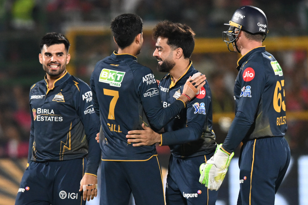 Gujarat Titans' Rashid Khan, centre, celebrates with teammates the wicket of Rajasthan Royals' Dhruv Jurel during the Indian Premier League cricket match between Rajasthan Royals and Gujarat Titans in Jaipur, India, Saturday, May 9, 2026. (AP Photo/ Str)