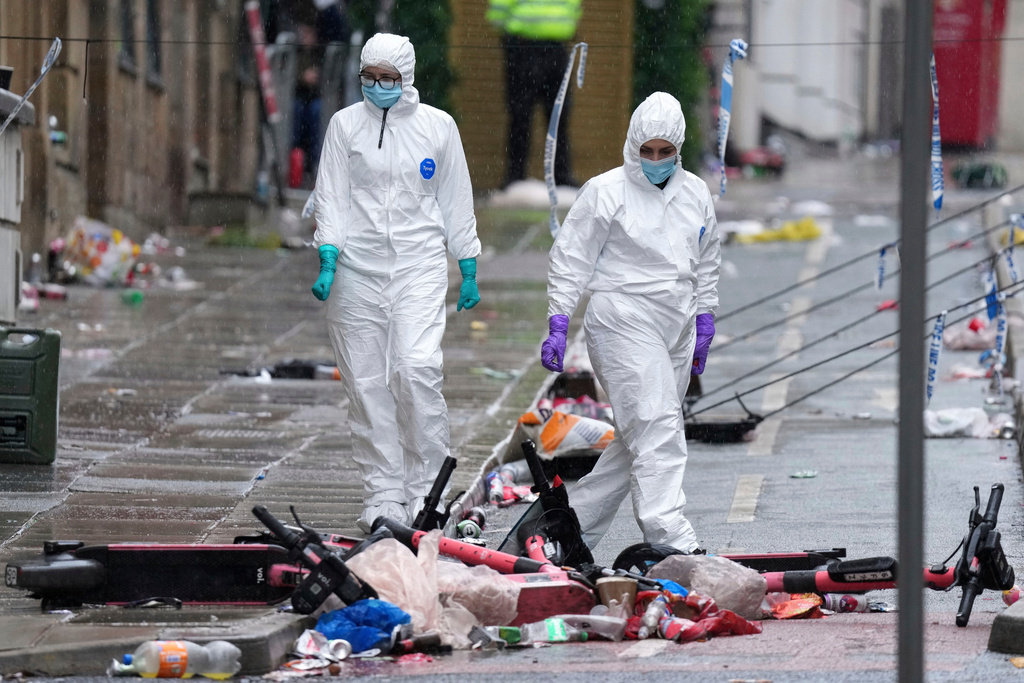 FILE - Forensic officers examine the site where a British man plowed a minivan into a crowd of Liverpool soccer fans who were celebrating the city's Premier League championship, injuring more than 45 people in Liverpool, England, May 27, 2025. (AP Photo/Jon Super, File)