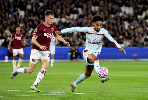 West Ham United's Oliver Scarles, left, and Brentford's Kevin Schade battle for the ball during the English Premier League soccer match between West Ham United and Brentford at the London Stadium, London, Monday Oct. 20, 2025. (Steven Paston/PA via AP) West Ham United's Oliver Scarles, left, and Brentford's Kevin Schade battle for the ball during the English Premier League soccer match between West Ham United and Brentford at the London Stadium, London, Monday Oct. 20, 2025. (Steven Paston/PA via AP)