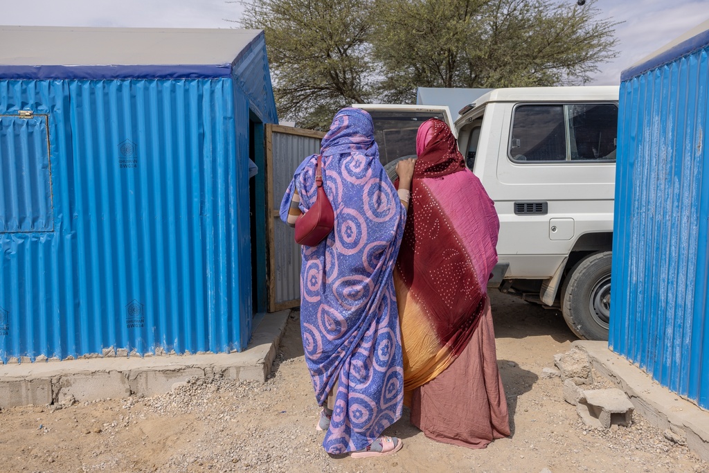 Relatives of a young Malian woman being treated for her dangerously high fever and infection by doctors at the Douankaran health clinic leave the hospital in the Hodh El Chargui Region, Mauritania, Nov. 7, 2025. (AP Photo/Caitlin Kelly)