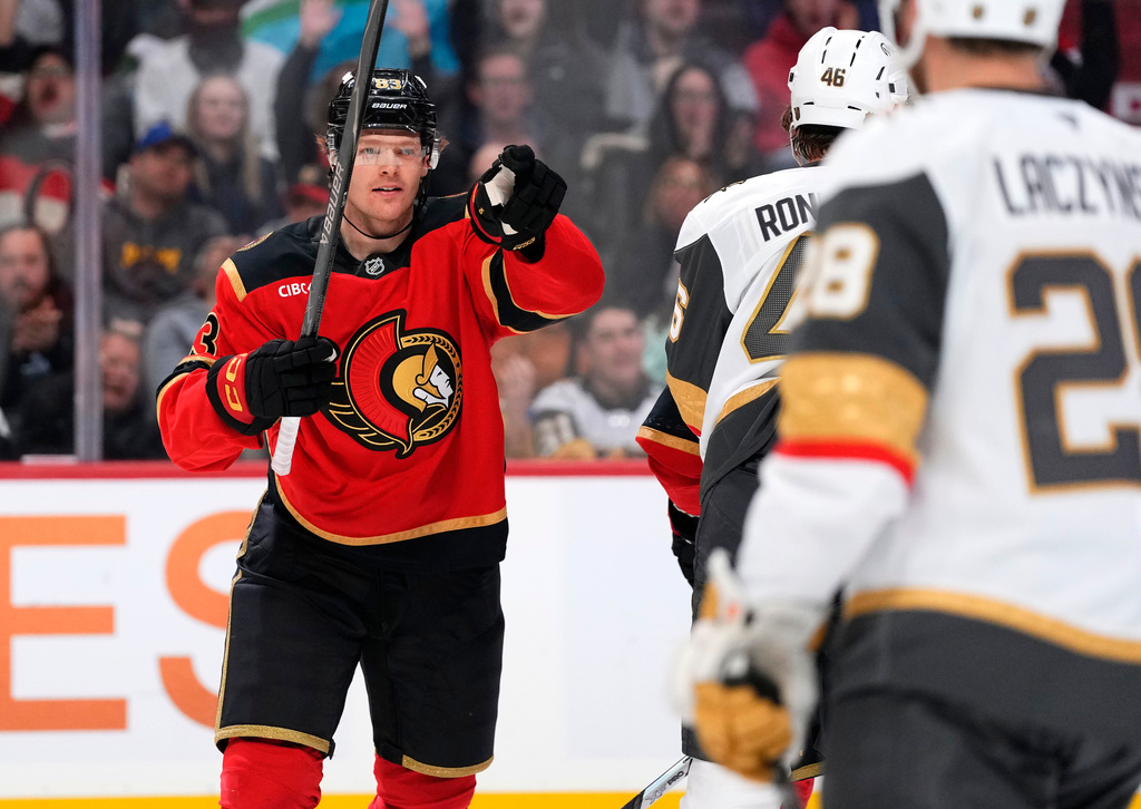 Ottawa Senators' Stephen Halliday, left, points toward teammate Tim Stutzle (not shown), who earned an assist, as he celebrates after scoring against the Vegas Golden Knights during second-period NHL hockey game action in Ottawa, Ontario, Sunday, Jan. 25, 2026. (Justin Tang/The Canadian Press via AP)
