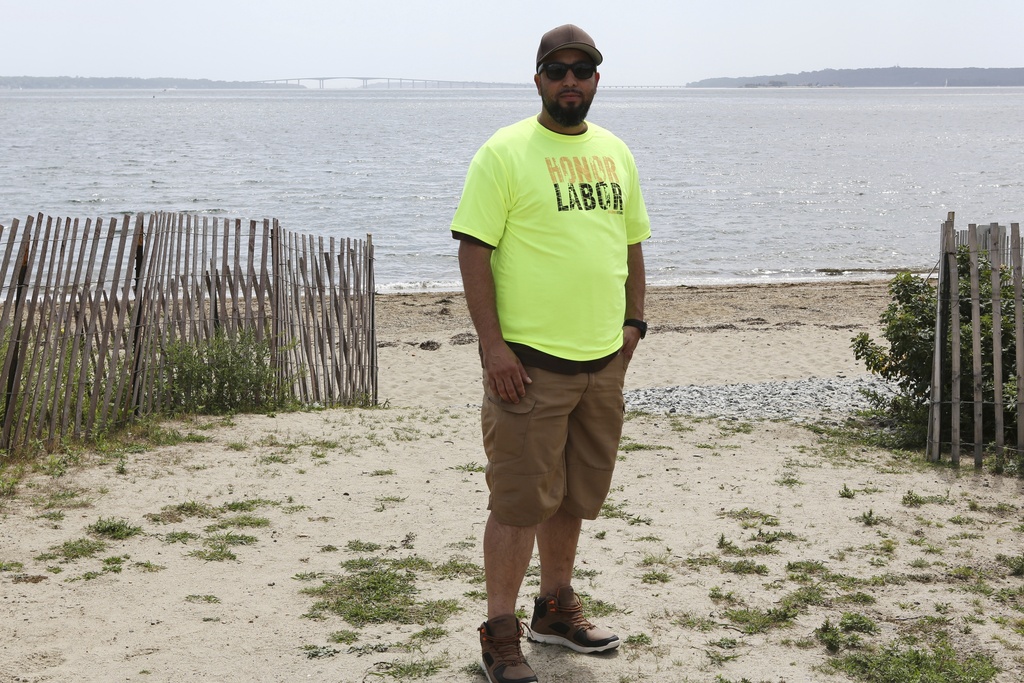 Tony Vaz, a rope access technician, stands near the beach in North Kingstown, R.I., Monday, Aug. 25, 2025, after a news conference where Democratic politicians and union members, including Vaz, called on the Trump administration to allow work to continue on the Revolution Wind offshore wind farm. (AP Photo/Jennifer McDermott)