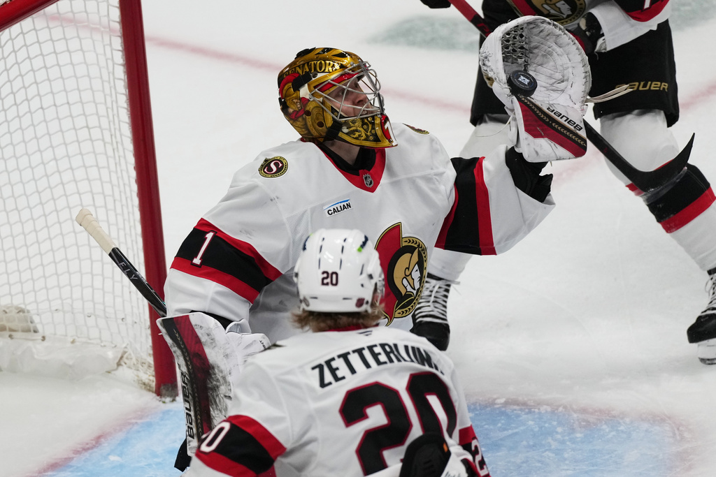 Ottawa Senators goaltender Leevi Meriläinen makes a glove-save in the first period of an NHL hockey game against the Colorado Avalanche, Thursday, Jan. 8, 2026, in Denver. (AP Photo/David Zalubowski)