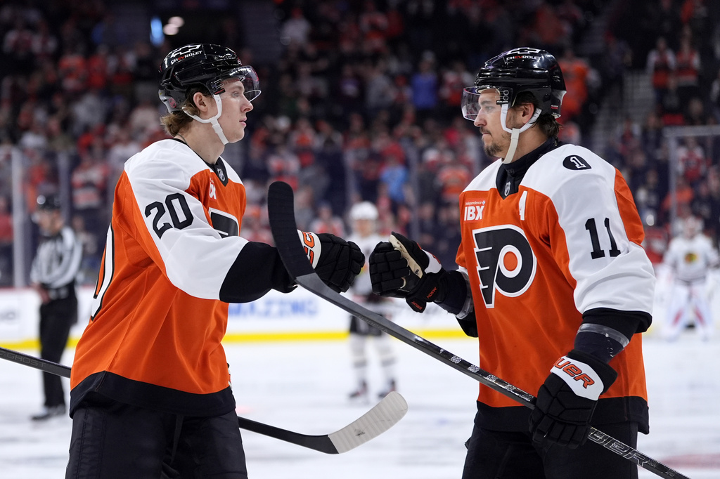 Philadelphia Flyers' Alex Bump, left, and Travis Konecny celebrate after a goal by Bump during the first period of an NHL hockey game against the Chicago Blackhawks Thursday, March 26, 2026, in Philadelphia. (AP Photo/Matt Slocum)