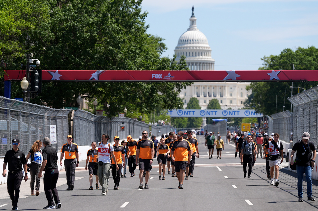 Racing teams walk the track before Sunday's Freedom 250 Grand Prix auto race, seen Friday, Aug. 21, 2026, in Washington. (AP Photo/Alex Brandon)
