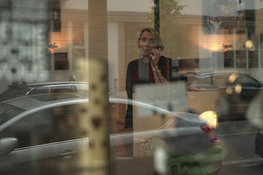 Véronique Bertrand, a funeral director, works the phones Sunday, June 28, 2026, at her office in Paris. (AP Photo/John Leicester)