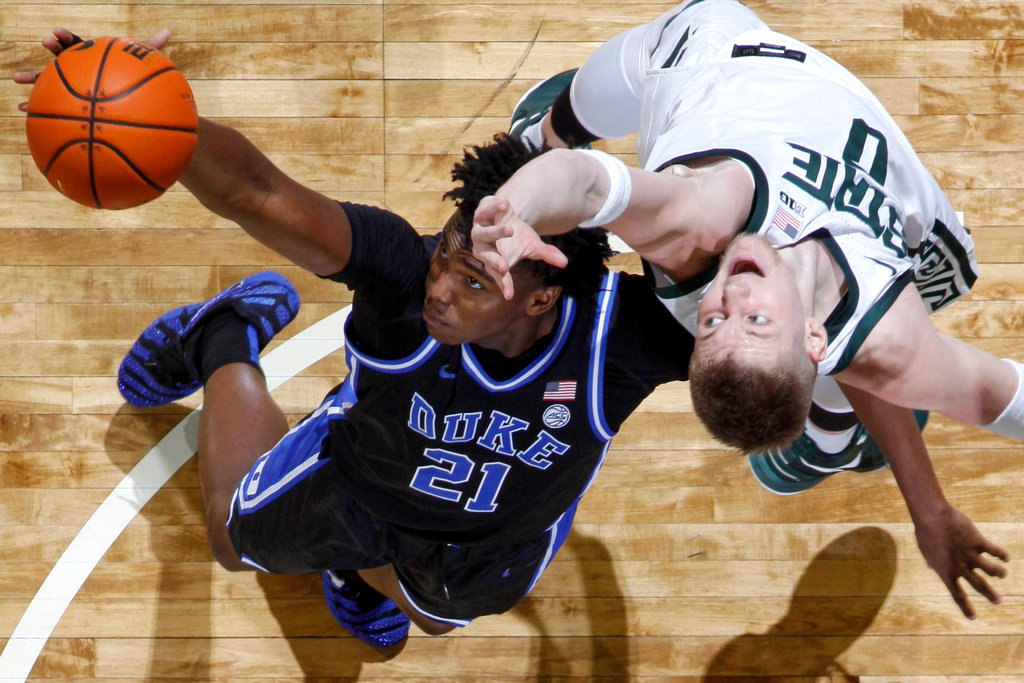Duke center Patrick Ngongba (21), and Michigan State forward Jaxon Kohler (0) vie for a rebound during the first half of an NCAA college basketball game Saturday, Dec. 6, 2025, in East Lansing, Mich. (AP Photo/Al Goldis)