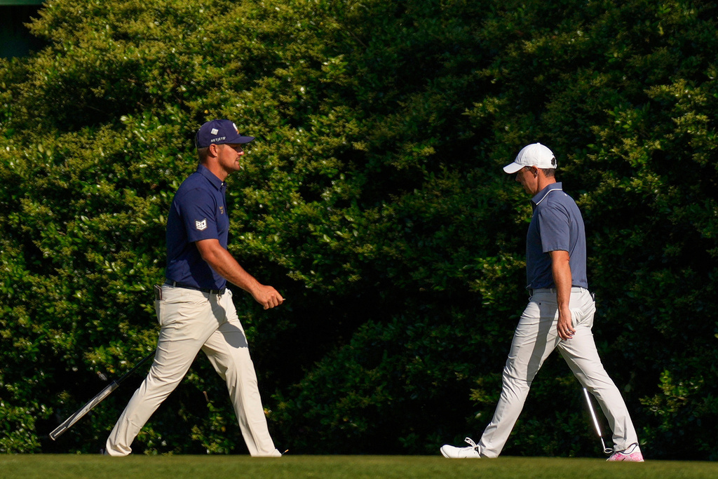 Bryson DeChambeau, left, and walk Rory McIlroy, of Northern Ireland, walk on the 11th hole during the final round at the Masters golf tournament, Sunday, April 13, 2025, in Augusta, Ga. (AP Photo/George Walker IV, File)