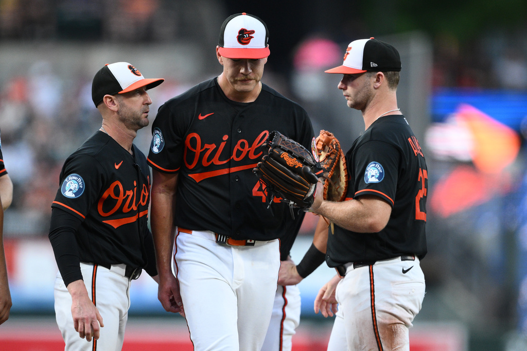 Baltimore Orioles pitcher Trey Gibson, center, is pulled by manager Craig Albernaz, left, during the third inning of a baseball game against the Chicago White Sox, Tuesday, June 30, 2026, in Baltimore. (AP Photo/Nick Wass)