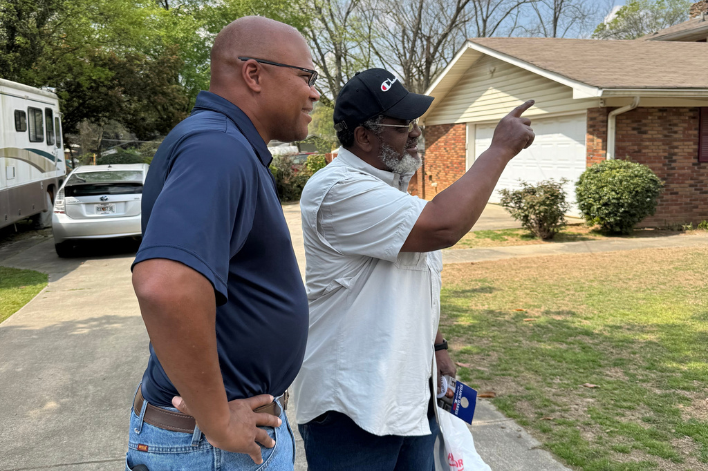 Democratic candidate Shawn Harris talks with a voter on Thursday, March 26, 2026 in Rome, Ga. (AP Photo/Charlotte Kramon)