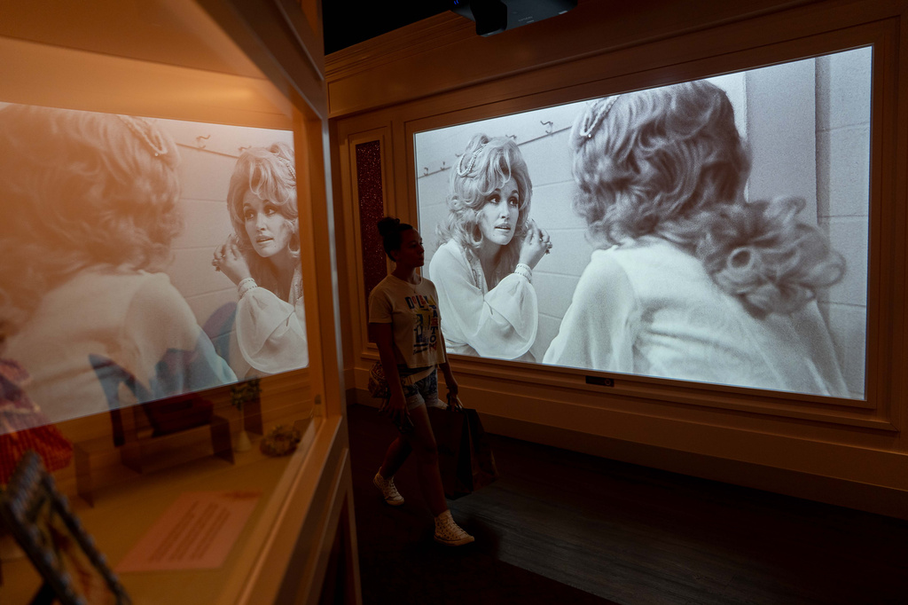 A visitor walks through a Dolly Parton exhibit at the Dollywood theme park in Pigeon Forge, Tenn., Wednesday, Aug. 26, 2026. (AP Photo/Camden Hall)