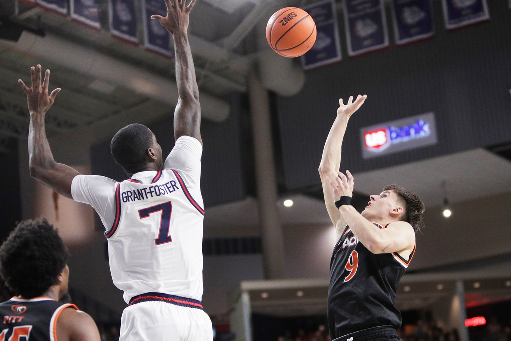 Pacific guard Kajus Kublickas (9) shoots while pressured by Gonzaga guard Tyon Grant-Foster (7) during the first half of an NCAA college basketball game Saturday, Feb. 21, 2026, in Spokane, Wash. (AP Photo/Young Kwak)