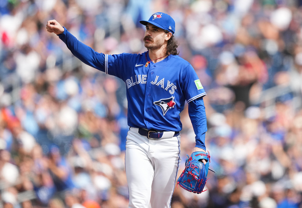 Toronto Blue Jays pitcher Dylan Cease reacts to the crowd and teammates after getting out of a jam with the bases loaded during the first inning of a baseball game against the Baltimore Orioles in Toronto, Sunday, Sept. 13, 2026. (Nathan Denette/The Canadian Press via AP)
