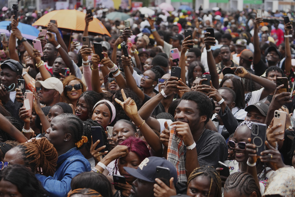 People watch as Chef Hilda Baci attempts to cook the world's largest pot of Jollof Rice in Lagos, Nigeria, Friday, Sept 12, 2025. (AP Photo/Sunday Alamba)