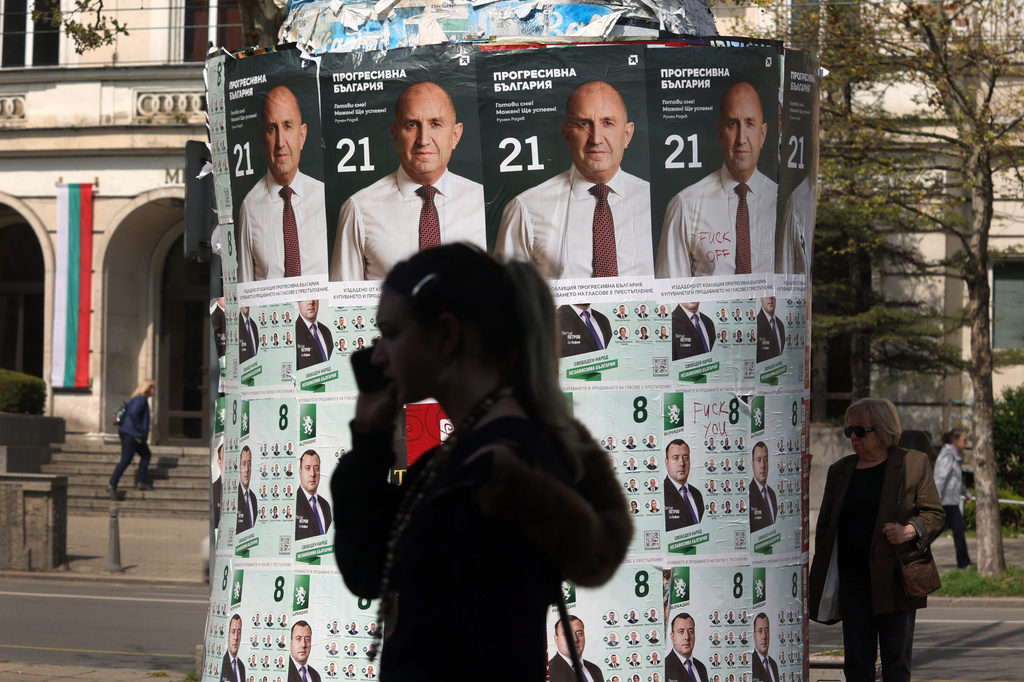 People pass posters of former president Rumen Radev, after Bulgaria's parliamentary election, in Sofia, Monday, April 20, 2026. (AP Photo/Valentina Petrova)