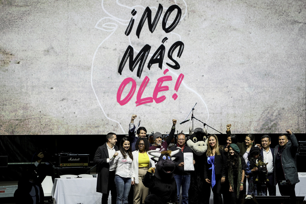 FILE - Colombian President Gustavo Petro holds up a law that bans bullfighting, in La Plaza Santa Maria, Bogota, Colombia, July 22, 2024. (AP Photo/Ivan Valencia, File)