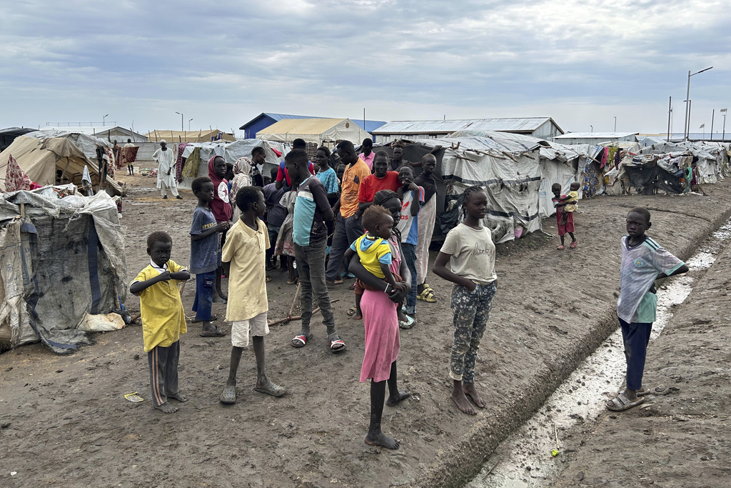 Children gather at the Renk transit center, which hosts people fleeing the war in Sudan, in Renk, South Sudan, Saturday, Aug 9, 2025. (AP Photo/Joseph Falzetta)