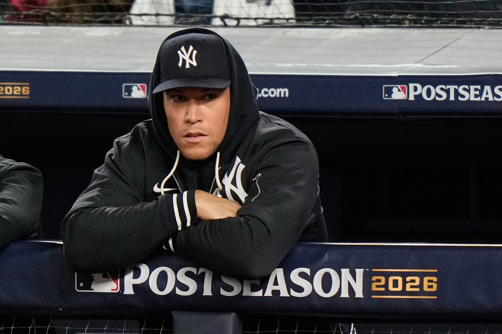 New York Yankees' Aaron Judge stands in the dugout watching play against the Tampa Bay Rays during the second inning in Game 3 of baseball's American League Division Series, Wednesday, Oct. 7, 2026, in New York. (AP Photo/Seth Wenig)