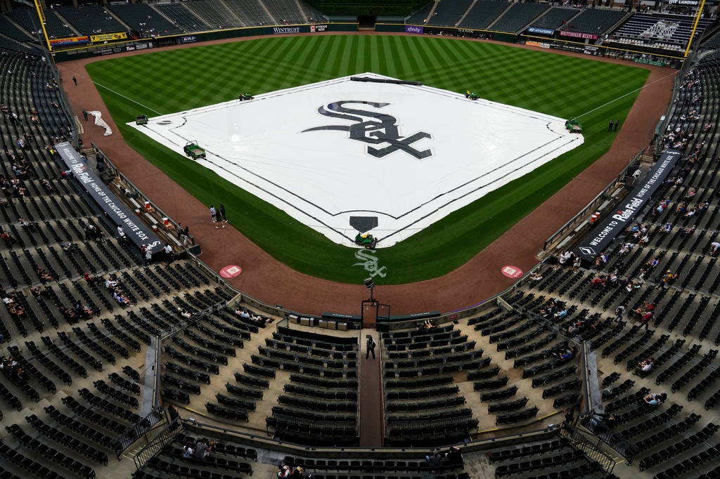 A tarp covers the infield during a rain delay before a baseball game between the Atlanta Braves and the Chicago White Sox in Chicago, Thursday, June 11, 2026. (AP Photo/Nam Y. Huh)