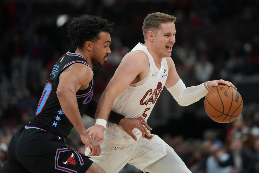 Cleveland Cavaliers guard Sam Merrill (5) handles the ball as Chicago Bulls guard Tre Jones (30) defends during the second half of an NBA basketball game Thursday, March 19, 2026, in Chicago. (AP Photo/Erin Hooley)