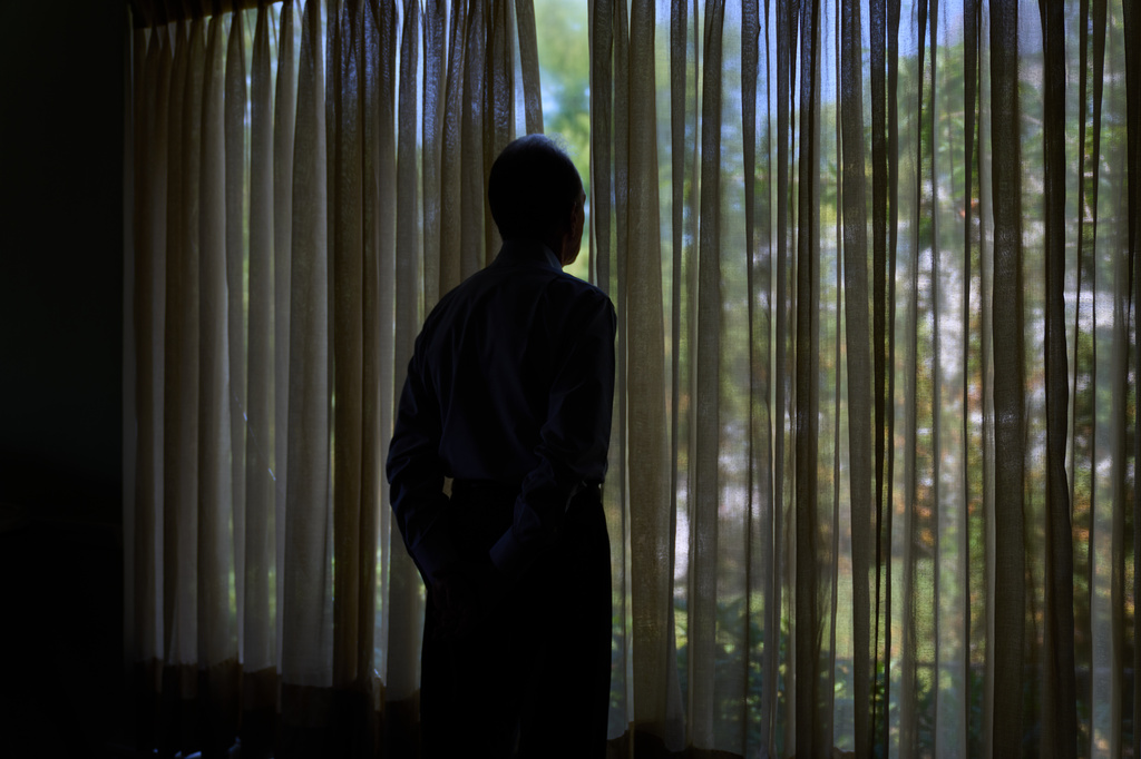 Simon, who was targeted by a scammer that stole $800,000 from his retirement savings and asked not to be identified by his full name because he's too ashamed to tell most of his family about the crime, looks out a window from his home, Wednesday, June 17, 2026, at his home in southeastern New York. (AP Photo/David Goldman)