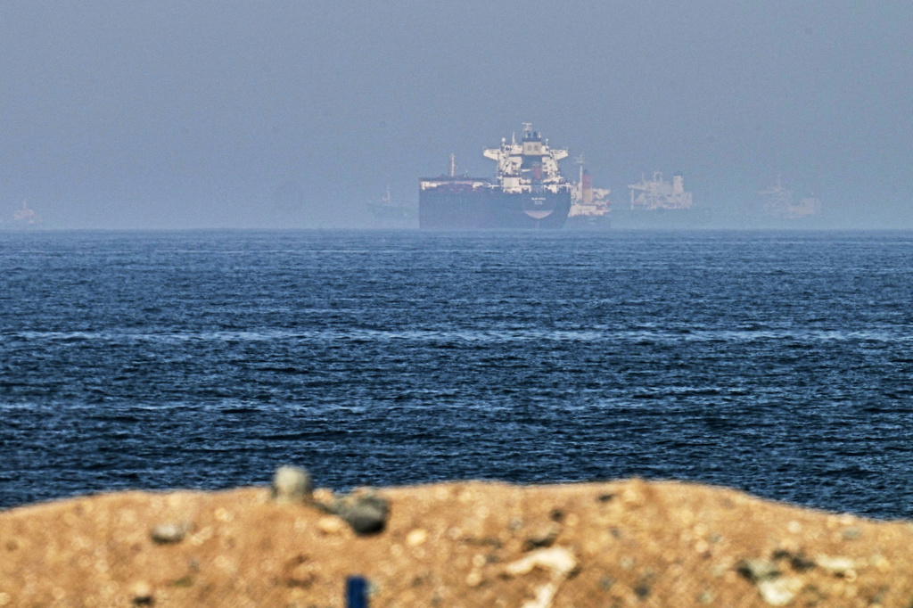 FILE - Cargo ships are seen at sea near the Strait of Hormuz, as viewed from a rocky shoreline near Khor Fakkan, United Arab Emirates, Friday, May 1, 2026. (AP Photo/Fatima Shbair, File)