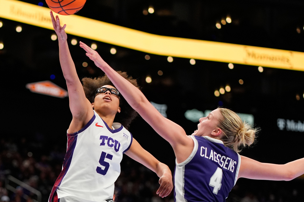 TCU's Olivia Miles (5) shoots over Kansas State's Nastja Claessens (4) during second half of an NCAA college basketball game in the semifinals of the Big 12 Conference tournament Saturday, March 7, 2026, in Kansas City, Mo. (AP Photo/Charlie Riedel)