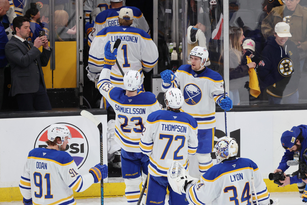 The Buffalo Sabres celebrate as they leave the ice after defeating the Boston Bruins in Game 4 of a first-round NHL hockey Stanley Cup playoff series, Sunday, April 26, 2026, in Boston. (AP Photo/Michael Dwyer)