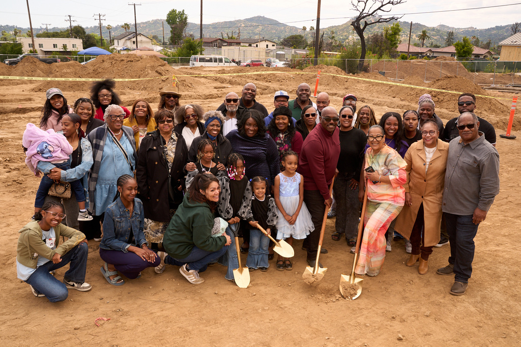 Pastor Jonathan Lewis poses for a photo with his congregation during a groundbreaking service at the site of the burned Fountain of Life Nazarene Church, marking the beginning of its rebuilding, April 26, 2026, in Altadena, Calif. (AP Photo/Damian Dovarganes)
