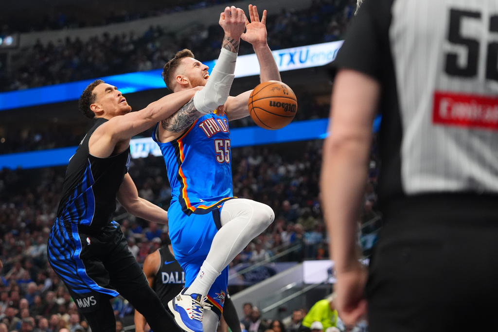 Oklahoma City Thunder center Isaiah Hartenstein (55) is fouled by Dallas Mavericks forward Dwight Powell during the first half of an NBA basketball game in Dallas, Sunday, March 1, 2026. (AP Photo/LM Otero)