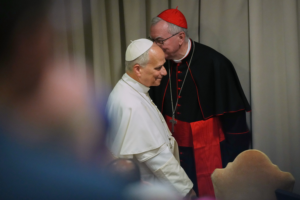 Pope Leo XIV, left, arrives with Vatican Secretary of State Cardinal Pietro Parolin for the presentation of his first encyclical, "Magnifica humanitas: On Safeguarding the Human Person in the Time of Artificial Intelligence," at the Vatican, Monday, May 25, 2026. (AP Photo/Alessandra Tarantino)