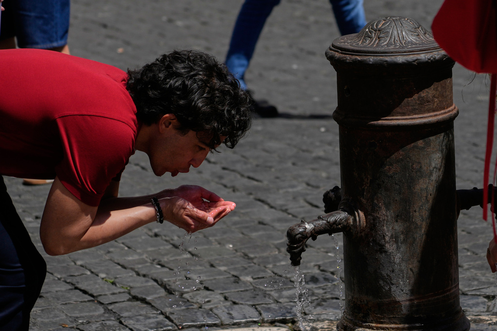 A man drinks water at a fountain in downtown Rome as temperatures are expected to reach 32 degrees Celsius (89.6 Fahrenheit), Tuesday, May 26, 2026. (AP Photo/Gregorio Borgia)