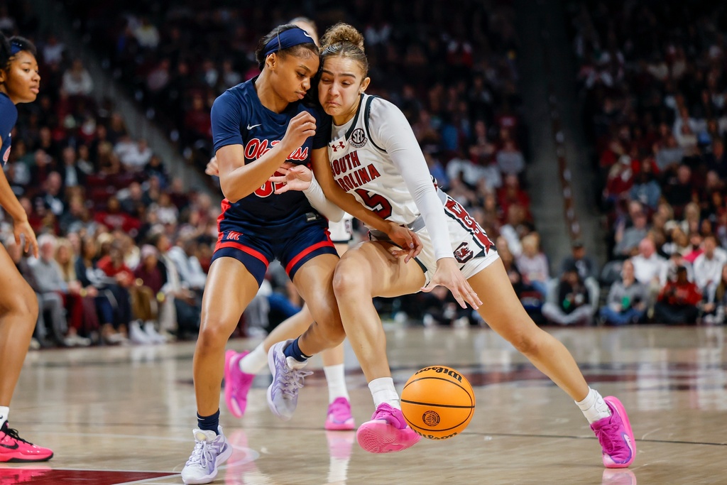 South Carolina guard Tessa Johnson, right, collides with Mississippi guard Tianna Thompson during the first half of an NCAA college basketball game in Columbia, S.C., Sunday, Feb. 22, 2026. (AP Photo/Nell Redmond)