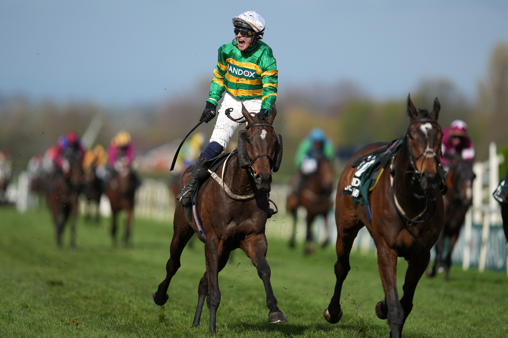 Jockey Paul Townend celebrates on I Am Maximus after winning the Grand National horse race at Aintree racecourse in Liverpool, Saturday, April 11, 2026. (AP Photo/Jon Super)