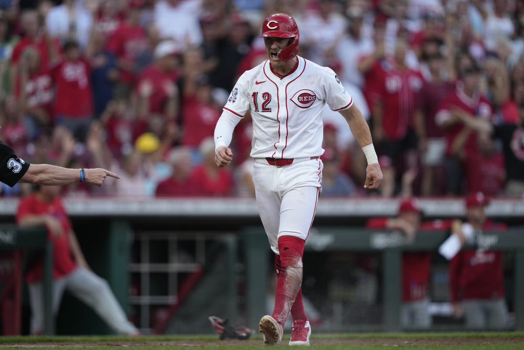 Cincinnati Reds' Austin Hays reacts after scoring on a double hit by Noelvi Marte during the fourth inning of a baseball game against the Philadelphia Phillies Wednesday, Aug. 13, 2025, in Cincinnati. (AP Photo/Carolyn Kaster)