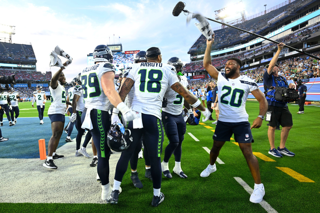 Seattle Seahawks tight end Elijah Arroyo (18) celebrates with teammates after catching a touchdown pass during the first half of a preseason NFL football game against the Tennessee Titans, Sunday, Aug. 23, 2026, in Nashville, Tenn. (AP Photo/John Amis)